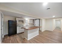 Open kitchen features white cabinetry, an island with wood countertop, and stainless steel appliances at 2009 N New York Ave, Muncie, IN 47304