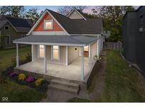 Charming home featuring a covered front porch, meticulous landscaping, and a blend of architectural styles at 2026 E 10Th St, Indianapolis, IN 46201