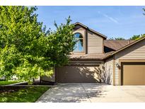 Charming two-story home with a well-manicured lawn and an attached two-car garage at 2247 Frisco Pl, Indianapolis, IN 46240