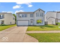Charming two-story home with a well-manicured lawn and attached two car garage at 2309 Westmere Dr, Plainfield, IN 46168