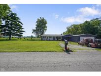 Ranch style home with a large front yard, detached garage and vintage truck at 2911 N 200 W Rd, Franklin, IN 46131