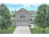 Charming two-story home with a well-maintained front yard and a two-car garage, perfect for Gathering living at 3075 W Crosscreek Dr, Monrovia, IN 46157