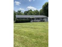 Charming single-story home with a well-manicured front yard and mature landscaping at 31 S Sugar Creek Dr, New Palestine, IN 46163