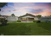 Charming single-story home featuring a well-maintained lawn and a detached garage at 3304 Coffey St, Indianapolis, IN 46217