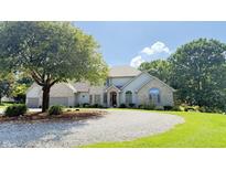 Well-maintained two-story home featuring professional landscaping and a circular gravel driveway at 5586 S 200 E, Franklin, IN 46131
