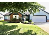 Charming, single-story home with blue siding, brick accents, well-maintained landscaping, and an attached garage at 7567 Muirfield Pl, Indianapolis, IN 46237