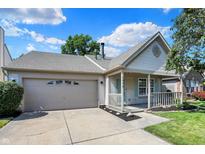 Charming single-story home boasts an attached garage, covered front porch, and well-maintained lawn at 9936 Waterside Dr, Noblesville, IN 46060