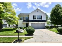 Charming two-story home with a well-manicured lawn and mature trees at 10539 Ross Xing, Fishers, IN 46038