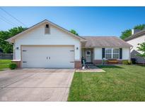 Charming one-story home with attached garage, well-manicured lawn and welcoming front porch at 1112 Berwyn Rd, Whiteland, IN 46184
