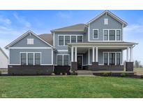 Charming two-story home featuring gray siding, black brick accents, and a well-manicured lawn at 1439 Chatham Hills Blvd, Westfield, IN 46074