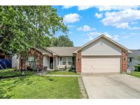 Charming home with brick accents, landscaped front yard, and a well-maintained lawn at 17401 Austrian Pine Way, Westfield, IN 46074