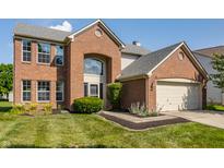 Charming brick two-story home with well-manicured lawn and attached two-car garage at 19469 Amber Way, Noblesville, IN 46060