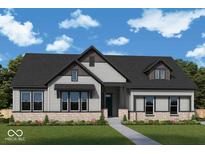 Charming single-story home with stone accents, gray siding, dark roof, and lush landscaping at 19832 Chatsworth Blvd, Westfield, IN 46074