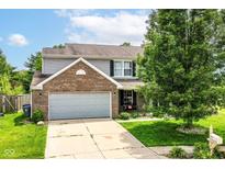 Charming two-story home featuring a brick facade, attached garage, and well-maintained landscaping at 2029 Seven Peaks Dr, Cicero, IN 46034