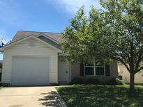 Charming single-Gathering home with well-maintained lawn, attached garage, and mature shade tree at 3929 Roundwood Dr, Indianapolis, IN 46235