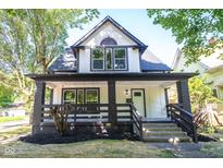 Charming two-story home with a welcoming front porch and landscaped yard at 402 N Oxford St, Indianapolis, IN 46201
