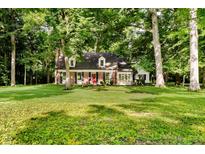 Charming brick home with a lush, green lawn and mature trees, offering a serene and private setting at 6280 N Chester Ave, Indianapolis, IN 46220