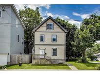 Charming two-story home featuring updated siding, front porch and manicured front lawn at 629 E 25Th St, Indianapolis, IN 46205