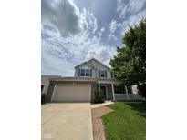 Charming two-story home with a brick and vinyl exterior, attached two-car garage and covered front porch at 6632 Coppel Ct, Indianapolis, IN 46259