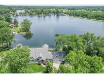 Breathtaking aerial view of a lake house, showcasing its lush surroundings and private dock at 9172 W Tulip Dr, Columbus, IN 47201