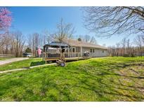 Charming single story home with an inviting deck and pergola overlooking the lush green lawn at 9267 N State Road 135, Morgantown, IN 46160