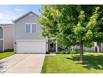 Charming two-story home with gray siding, a two-car garage, and a well-maintained front lawn at 9497 W Stargazer Dr, Pendleton, IN 46064