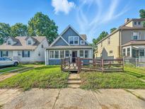 Charming two-story home featuring a spacious front yard on a sunny day at 1016 W 31St St, Indianapolis, IN 46208