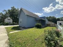 Charming blue house featuring a well-maintained lawn and sidewalk, inviting you to call it home at 1256 Kappes St, Indianapolis, IN 46221