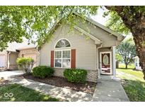 Charming single-story home featuring light siding, red shutters, and a well-manicured front yard at 1311 Flintlock Dr, Greenwood, IN 46143