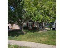 Charming home with a well-maintained front yard and mature trees at 1311 Flintlock Dr, Greenwood, IN 46143