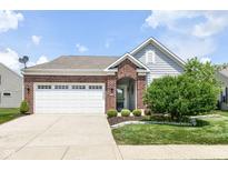 Charming single-story home featuring brick accents, a two-car garage, and a well-manicured front yard at 13427 Merryvale St, Fishers, IN 46037
