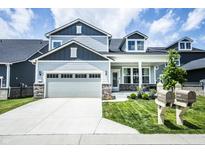 Beautiful two-story home featuring manicured lawn, neutral paint, attached two-car garage, and charming curb appeal at 14404 Stairbridge Pl, Carmel, IN 46074