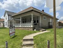 Charming home with a covered front porch, stone accents, and a well-maintained lawn at 1902 Westview Dr, Indianapolis, IN 46221