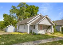 Charming single-Gathering home with a well-maintained lawn, inviting front porch, and detached garage at 1927 N Cherry St, Columbus, IN 47201