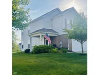 Charming two-story home with a covered porch, well-maintained lawn and American Flag at 2485 Blue Ridge Dr, Greenwood, IN 46143
