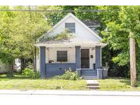 Charming two-story home featuring a quaint front porch and mature trees at 2650 S Meridian St, Indianapolis, IN 46225