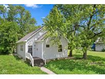 Charming single-story home with gray siding, mature trees, and a welcoming front entrance at 2709 Station St, Indianapolis, IN 46218