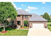 Charming two-story brick home with a well-manicured lawn and attached two car garage at 3050 Montgomery Blvd, Lapel, IN 46051
