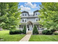 Charming gray two-story home with well-manicured lawn and inviting front porch at 3101 N Washington Blvd, Indianapolis, IN 46205