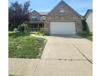 Charming two-story brick home with a well-maintained front yard and covered porch at 430 N Greenbriar Dr, Greenwood, IN 46142