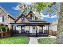Charming home featuring a covered front porch and a well-maintained lawn, creating a welcoming curb appeal at 44 S Tremont St, Indianapolis, IN 46222