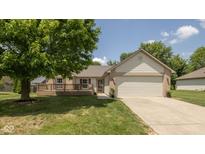 Charming single-story home with a front-facing wooden deck and a two-car garage at 5642 Southern Mist Dr, Indianapolis, IN 46237
