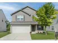 Charming two-story home with a two-car garage and a well-maintained front lawn at 5672 High Timber Ln, Indianapolis, IN 46235