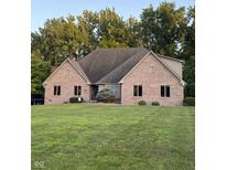 Charming brick home with well-manicured lawn and mature landscaping in front at 5993 E County Road 100 S, Avon, IN 46123