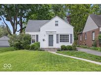 Charming single-Gathering home with a well-manicured lawn and a classic white facade at 6009 Ralston Ave, Indianapolis, IN 46220