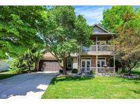 Charming two-story home featuring a double-deck porch and a well-manicured lawn at 6298 Briargate Dr, Zionsville, IN 46077