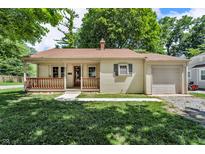 Charming single-story home with covered front porch, attached garage, and a lush green lawn at 696 W Mill St, Danville, IN 46122