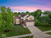 Charming two-story home features a well-manicured lawn, attached garage, and inviting curb appeal at 8835 Harrison Pkwy, Fishers, IN 46038