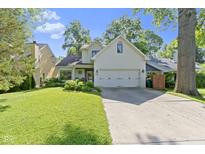 Charming home with a two-car garage, well-maintained lawn, and beautiful trees at 111 N 8Th St, Zionsville, IN 46077