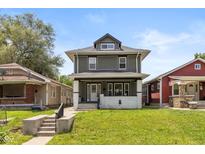Charming two-story home featuring a covered front porch and well-maintained landscaping at 1141 W 35Th St, Indianapolis, IN 46208